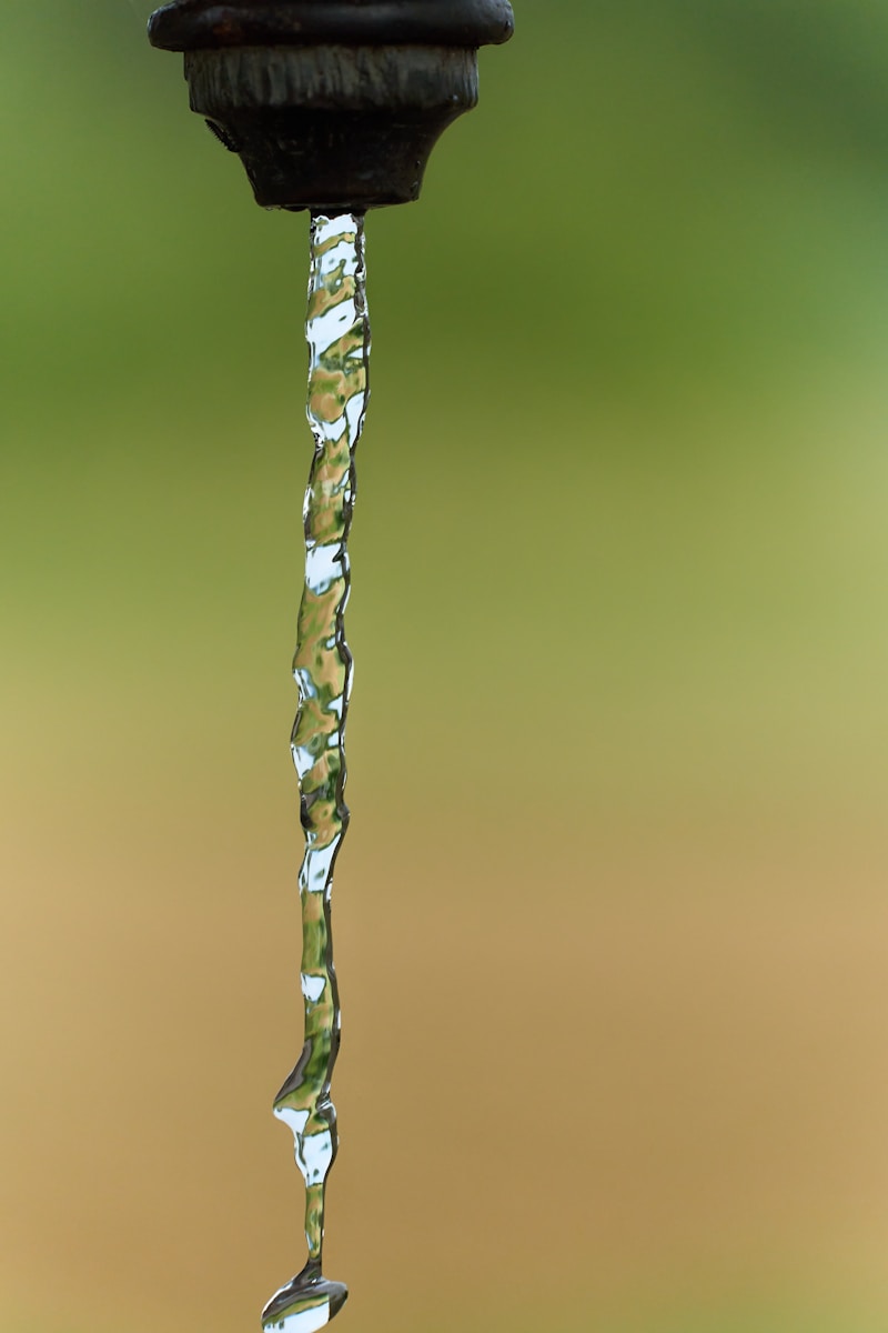 a faucet with water running down it's side, tds water dubai